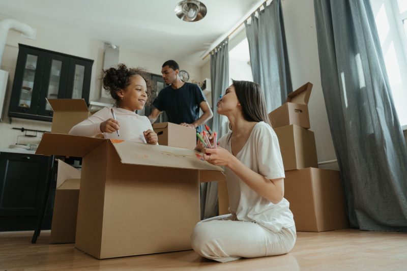 Home 9 A joyful family unpacking boxes while moving into their new 1793120483